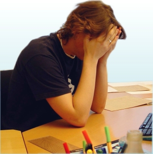 Stressed person at their desk. Photo by Carl Dwyer.